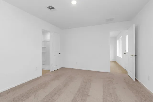 an empty room with windows and closet