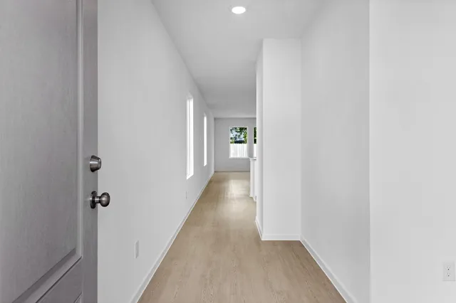 a kitchen with granite countertop a sink stove oven and refrigerator