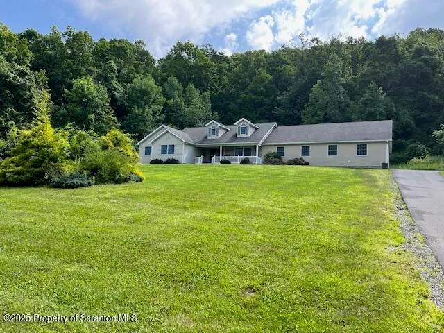a view of a house with a yard porch and sitting area