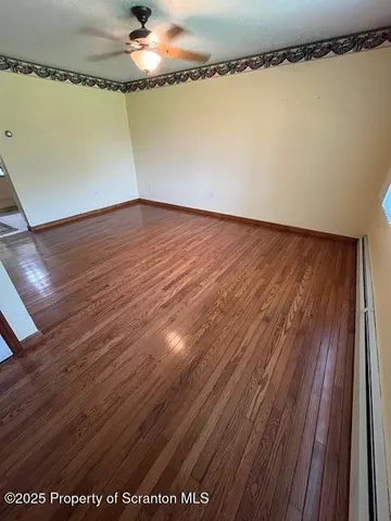 a view of a room with wooden floor