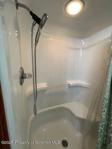 a bathroom with a bathtub and shower