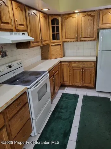 a kitchen with stainless steel appliances granite countertop a sink and a stove