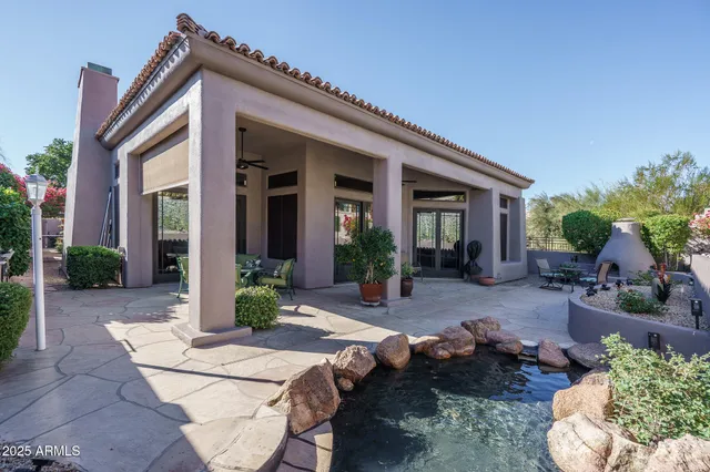 a view of a house with backyard sitting area and porch
