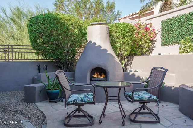 a view of a chairs and table in backyard