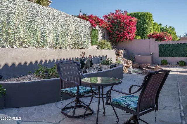a view of a chairs and table in patio