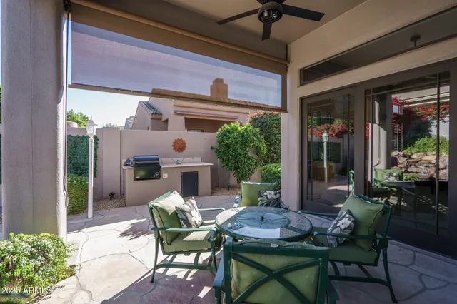 a view of a patio with a table and chairs