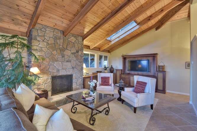 22154 Miller Ridge Road Los Gatos, CA 95033 - Photo 2 of 19 a living room with furniture and a fireplace