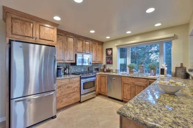 22154 Miller Ridge Road Los Gatos, CA 95033 - Photo 6 of 19 a kitchen with sink refrigerator and cabinets