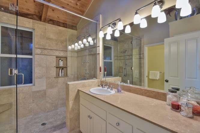 22154 Miller Ridge Road Los Gatos, CA 95033 - Photo 8 of 19 a bathroom with a sink vanity and a mirror