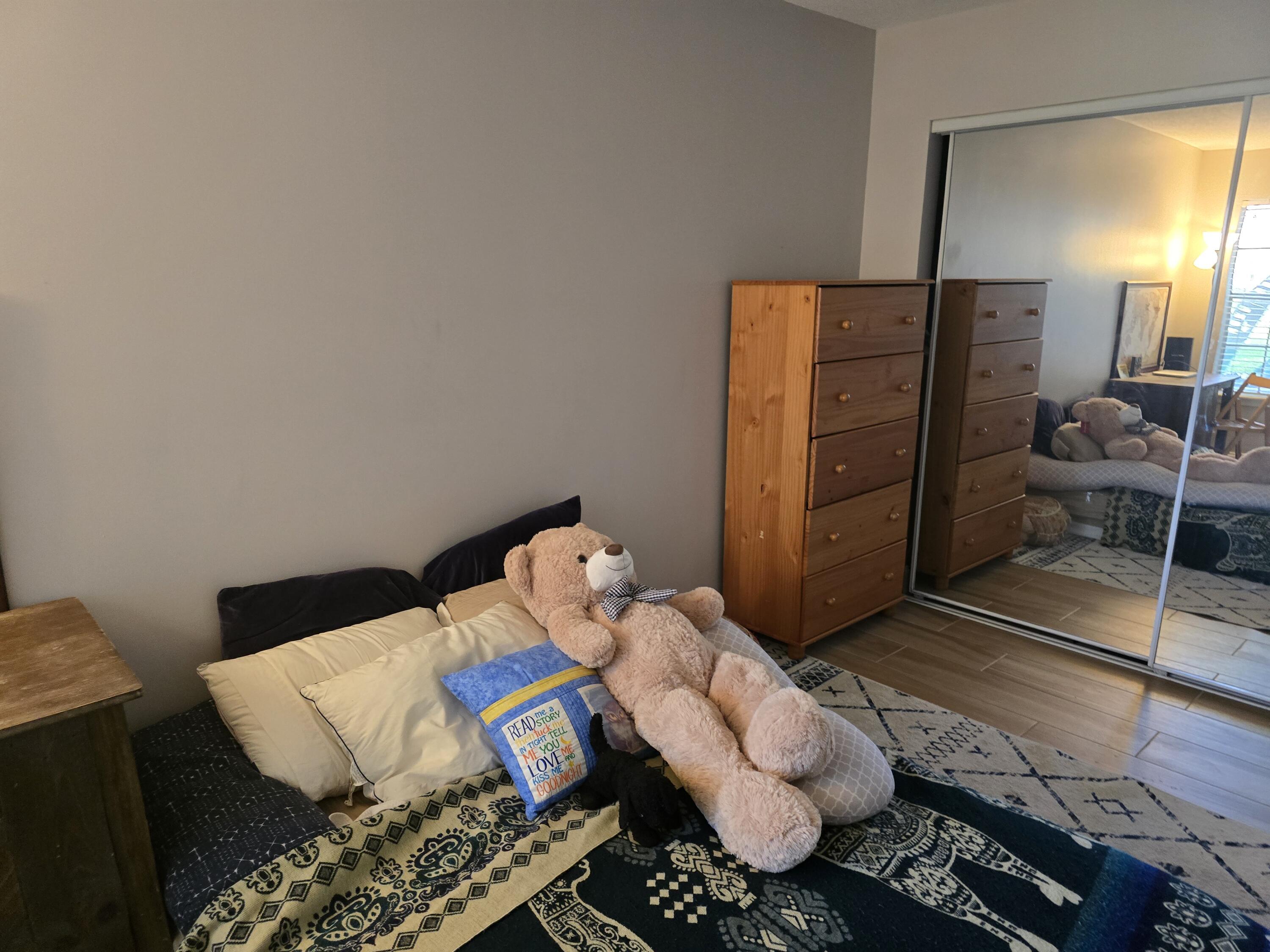 1215 Crystal Way, Unit O Delray Beach, FL 33444 - Photo 11 of 14 a bedroom with a bed and wooden floor