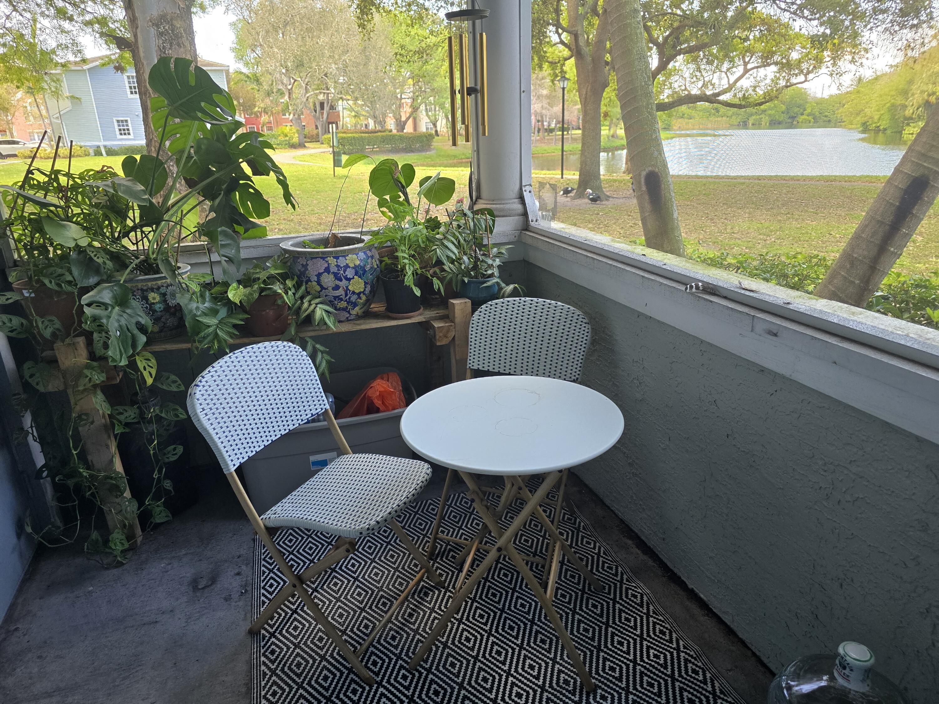 1215 Crystal Way, Unit O Delray Beach, FL 33444 - Photo 14 of 14 a view of a chairs and table in patio