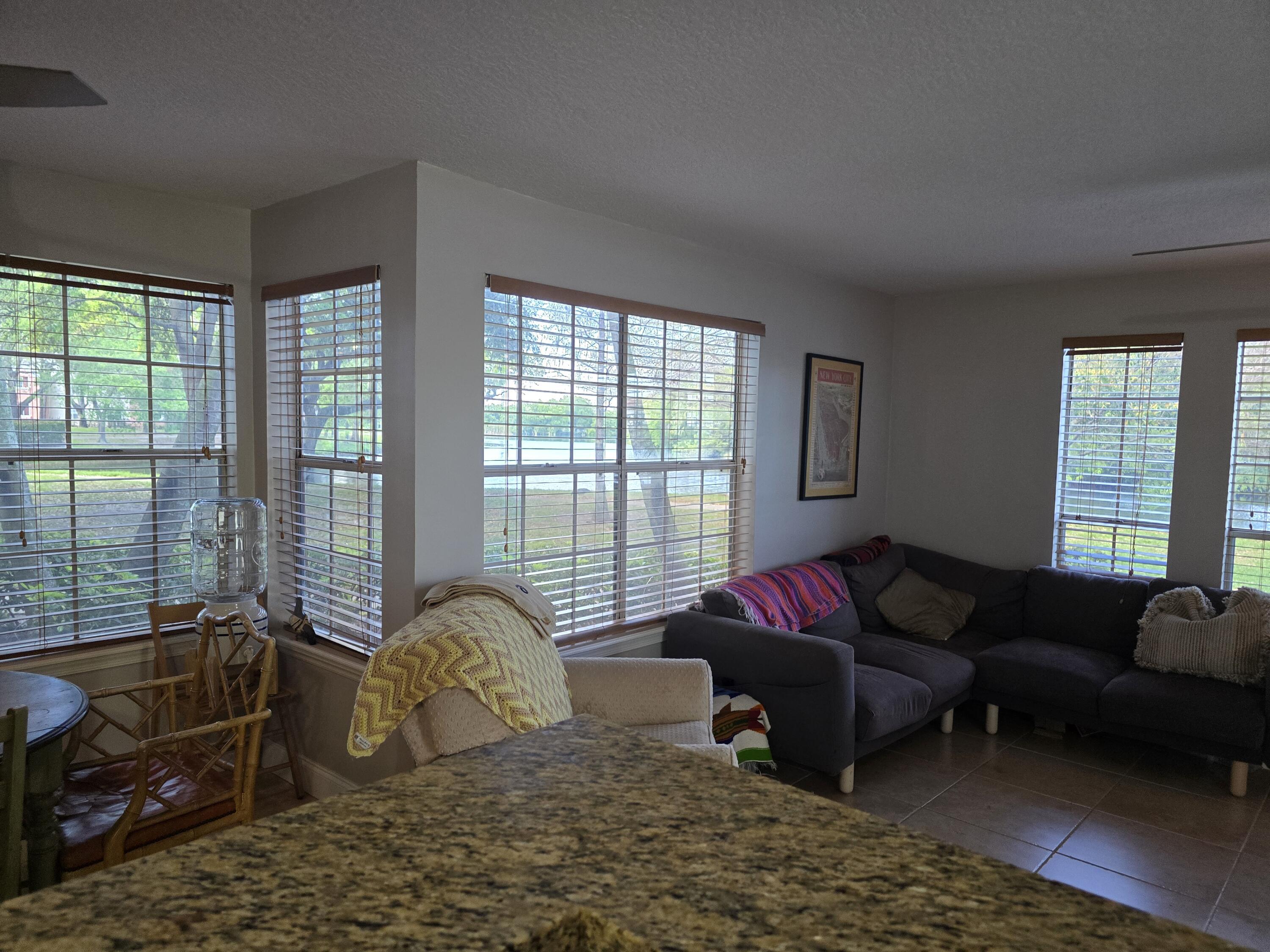 1215 Crystal Way, Unit O Delray Beach, FL 33444 - Photo 2 of 14 a living room with furniture window and a couch
