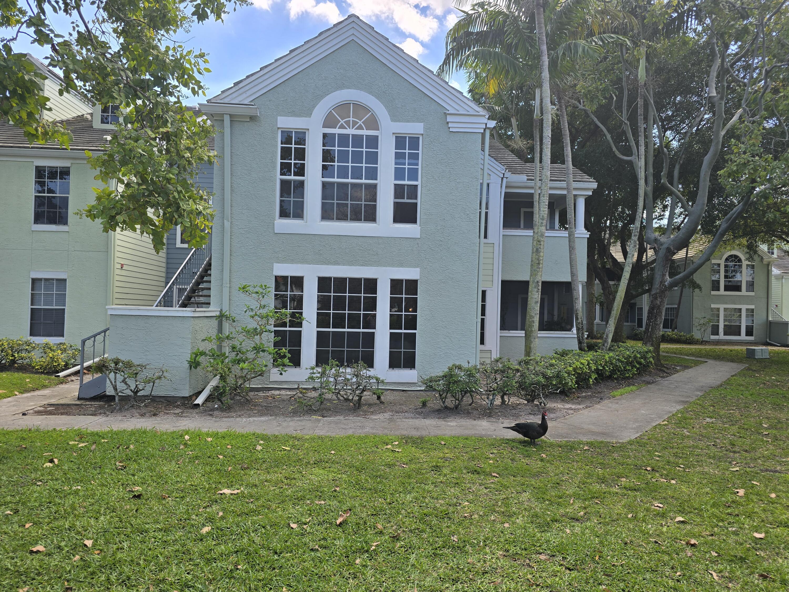 1215 Crystal Way, Unit O Delray Beach, FL 33444 - Photo 4 of 14 a front view of a house with garden