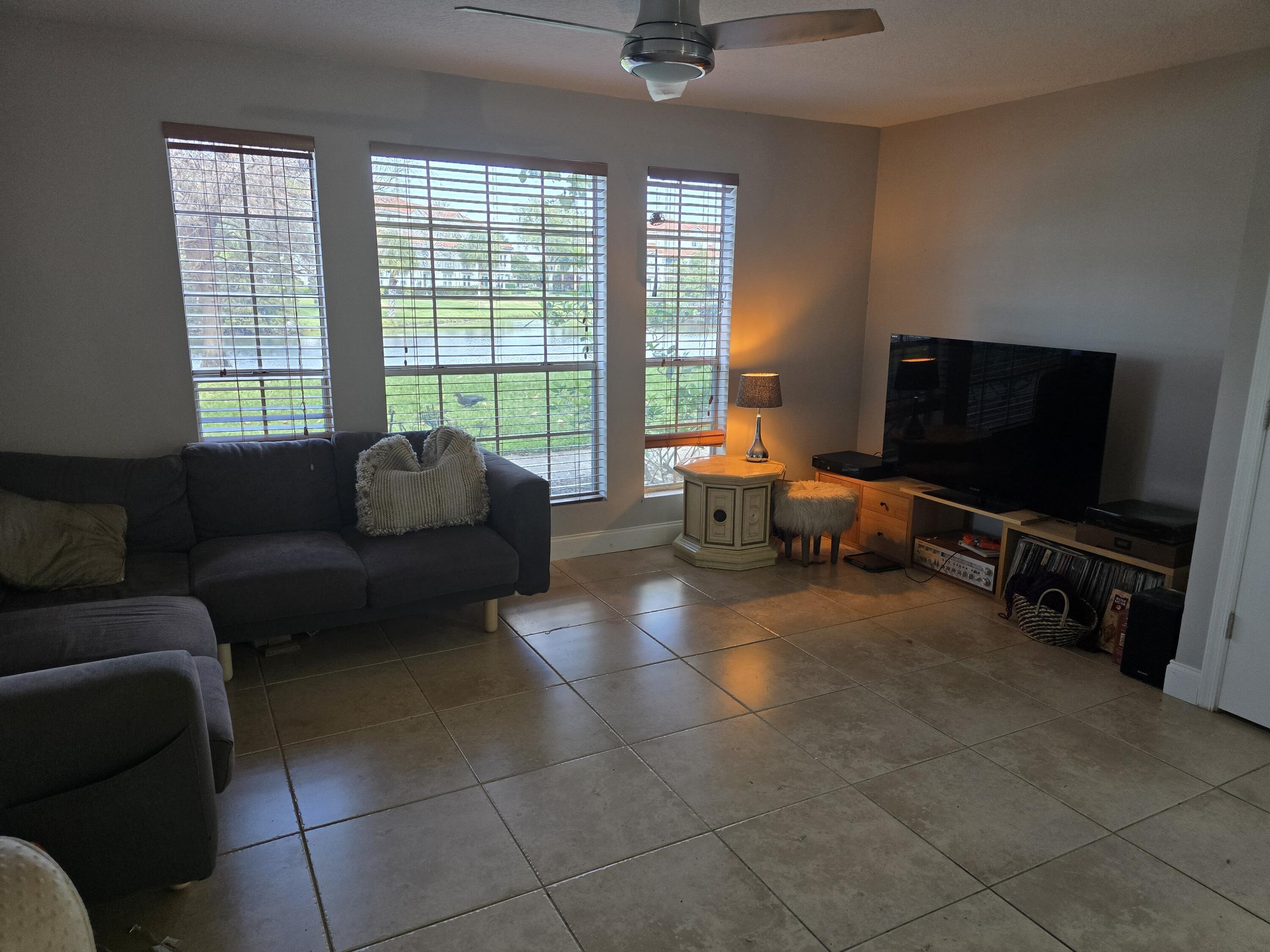 1215 Crystal Way, Unit O Delray Beach, FL 33444 - Photo 6 of 14 a living room with furniture and a flat screen tv