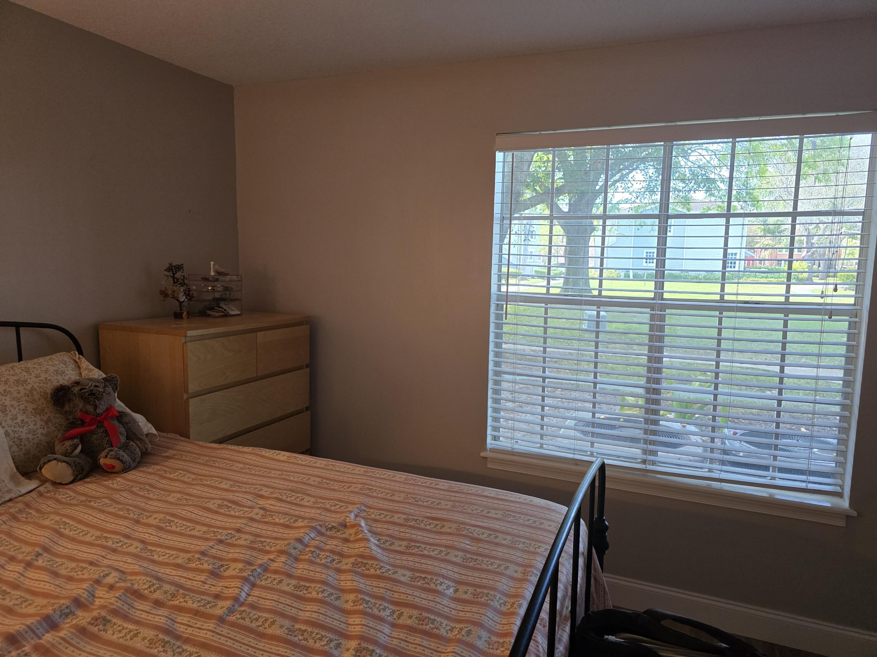 1215 Crystal Way, Unit O Delray Beach, FL 33444 - Photo 9 of 14 a bedroom with a bed and a window