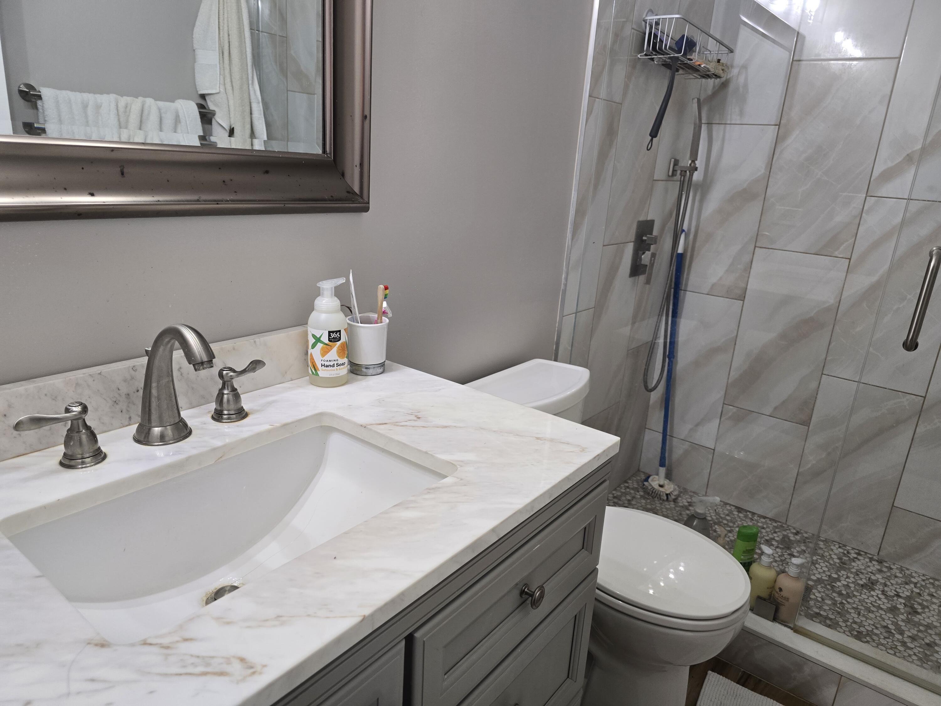 1215 Crystal Way, Unit O Delray Beach, FL 33444 - Photo 10 of 14 a bathroom with a sink and toilet