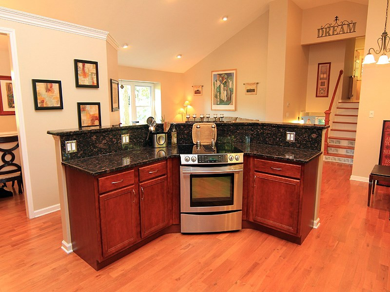 5328 Edington Lane Raleigh, NC 27604 - Photo 4 of 25 Large island with Granite tops and built-in electric range overlooks the sun filled living room.Great for entertainent Kitchen