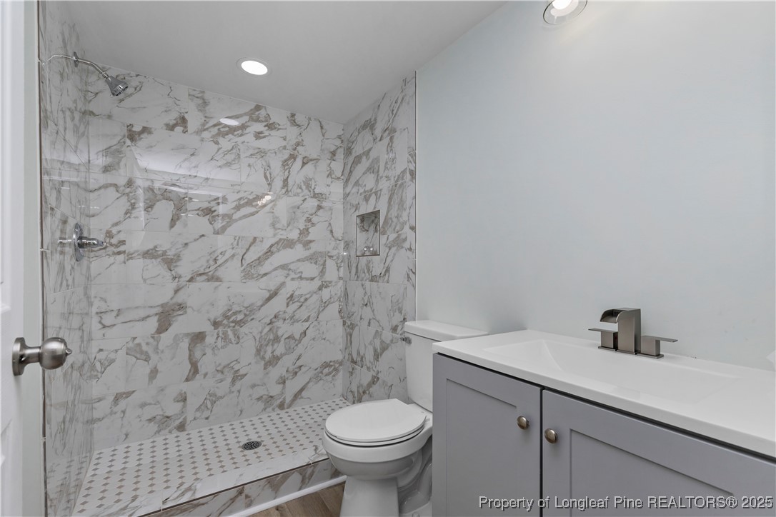 1340 George Perry Lee Road Dunn, NC 28334 - Photo 23 of 31 a bathroom with a sink toilet and a mirror