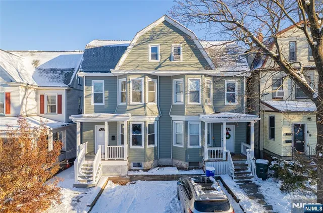 a front view of a residential apartment building with a yard
