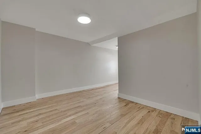 a living room with furniture a flat screen tv and a window