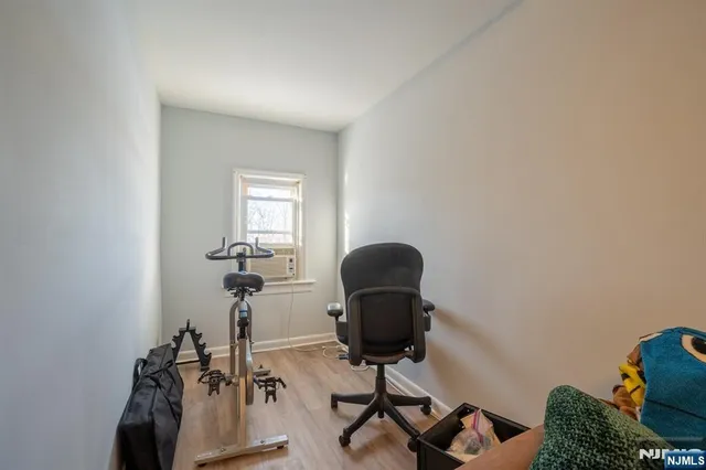 a view of a livingroom with furniture and a book shelf