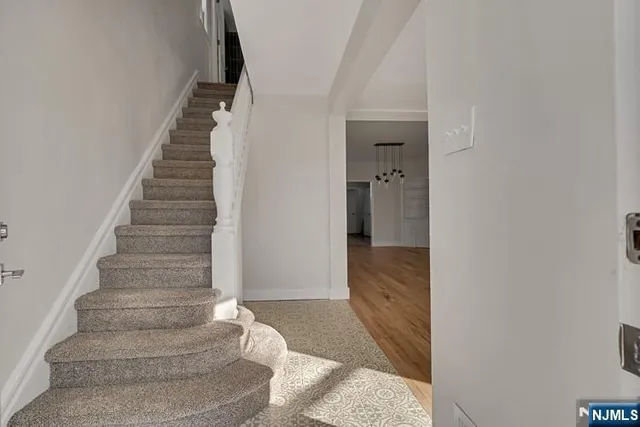 a view of a hallway with wooden floor and entryway