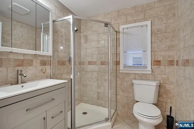 a kitchen with stainless steel appliances a refrigerator sink and wooden floor