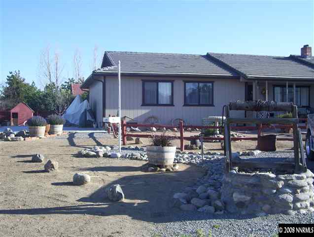 11590 Osage Road Reno, NV 89508 - Photo 7 of 9 a front view of a house with garden