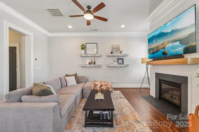 a living room with furniture and a chandelier