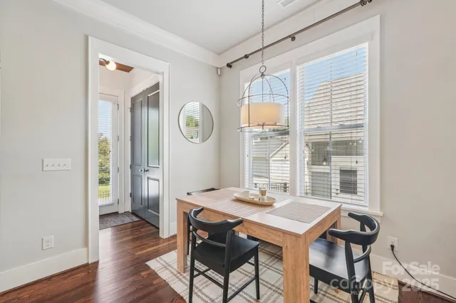 a living room with furniture a fireplace and a chandelier