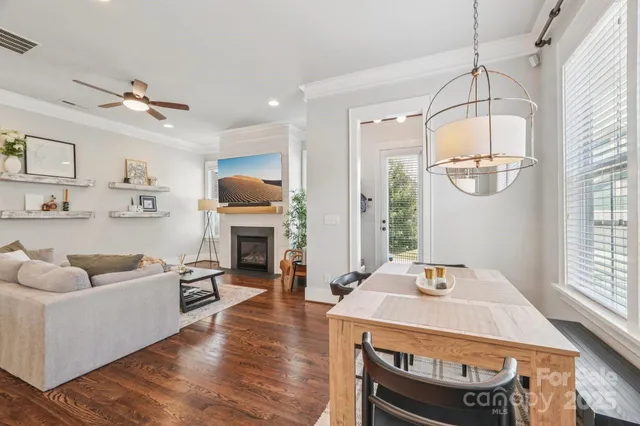 a kitchen with stainless steel appliances a stove a sink cabinets and a dining table