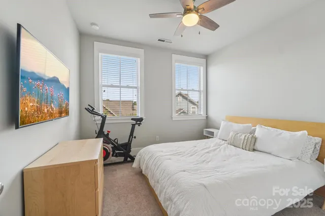 a bedroom with a bed and a painting on the wall