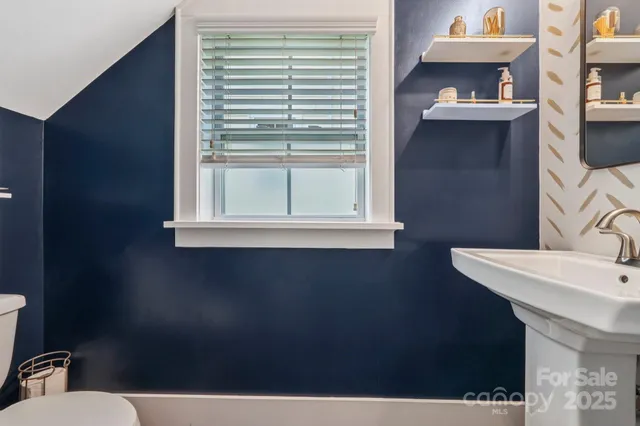 a view of a room that has a window and a shower