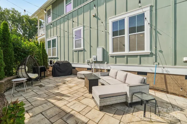 a backyard of a house with outdoor seating