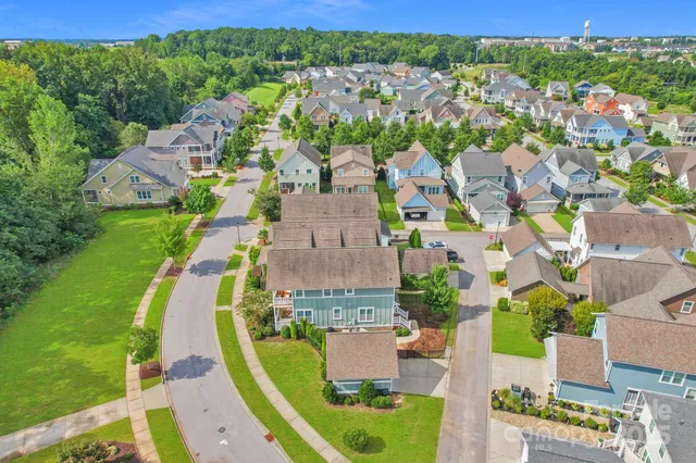 an aerial view of a house with a garden and pool