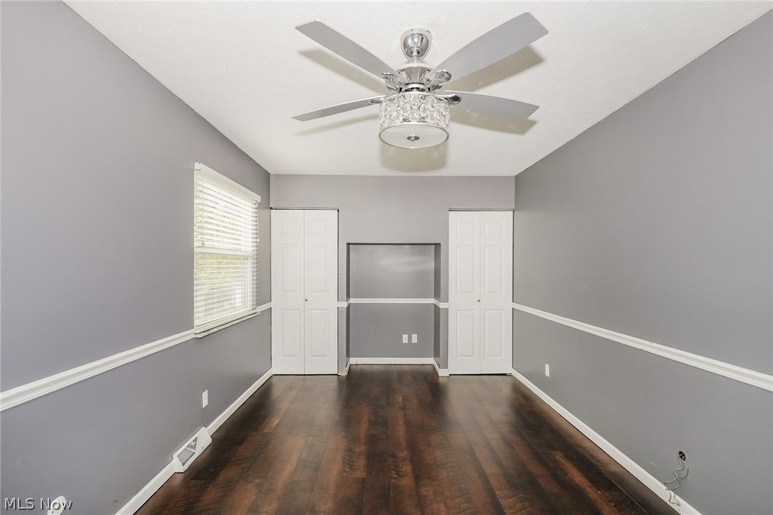 215 Randel Avenue Akron, OH 44313 - Photo 9 of 20 Empty room with dark wood-type flooring and ceiling fan