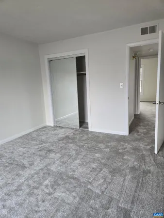 a view of an empty room and closet