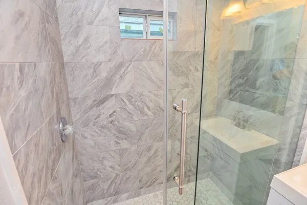 a bathroom with a sink and shower