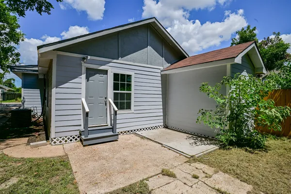 a view of a house with garage and plants