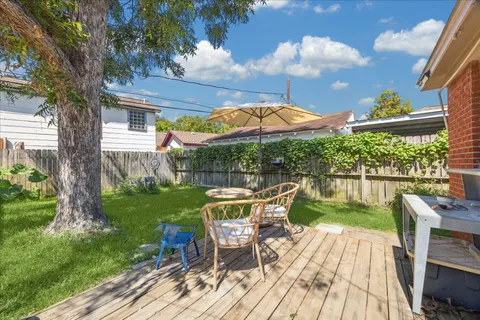 a view of a chair and table in backyard of the house