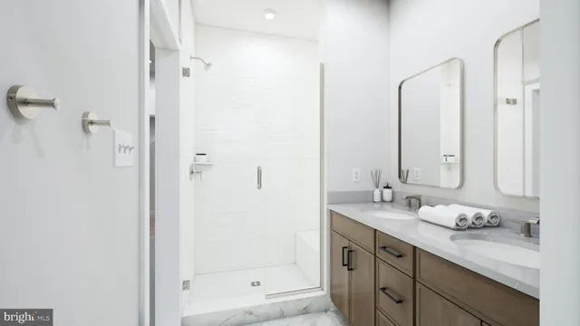 a bathroom with a granite countertop sink mirror and double