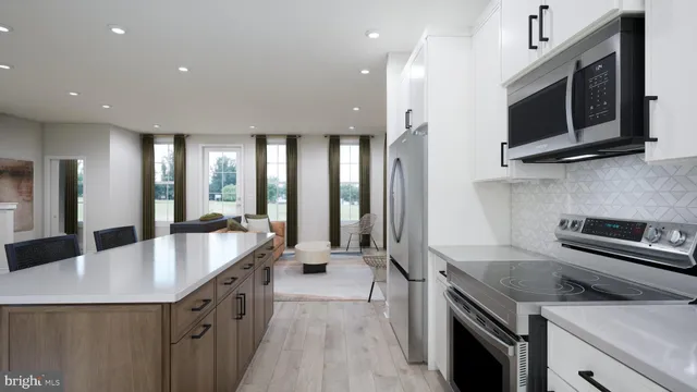 a large kitchen with stainless steel appliances granite countertop a lot of counter space