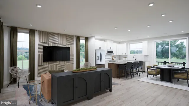 a living room with furniture a flat screen tv and floor to ceiling window
