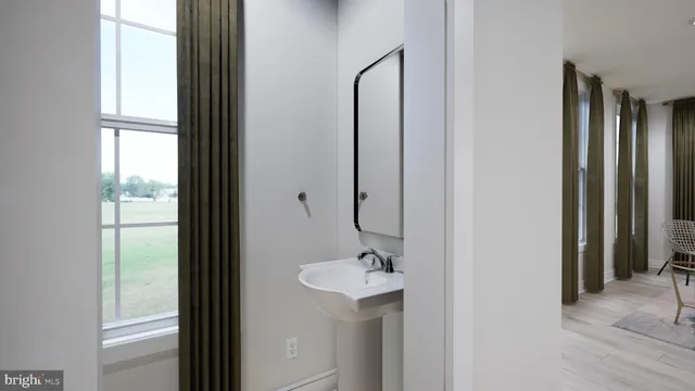 a bathroom with a sink a mirror and a window