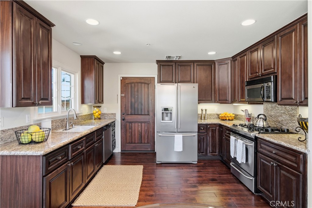 2454 Oswego Street, Unit 301 Pasadena, CA 91107 - Photo 15 of 59 a kitchen with stainless steel appliances granite countertop a refrigerator a stove top oven a sink and dishwasher