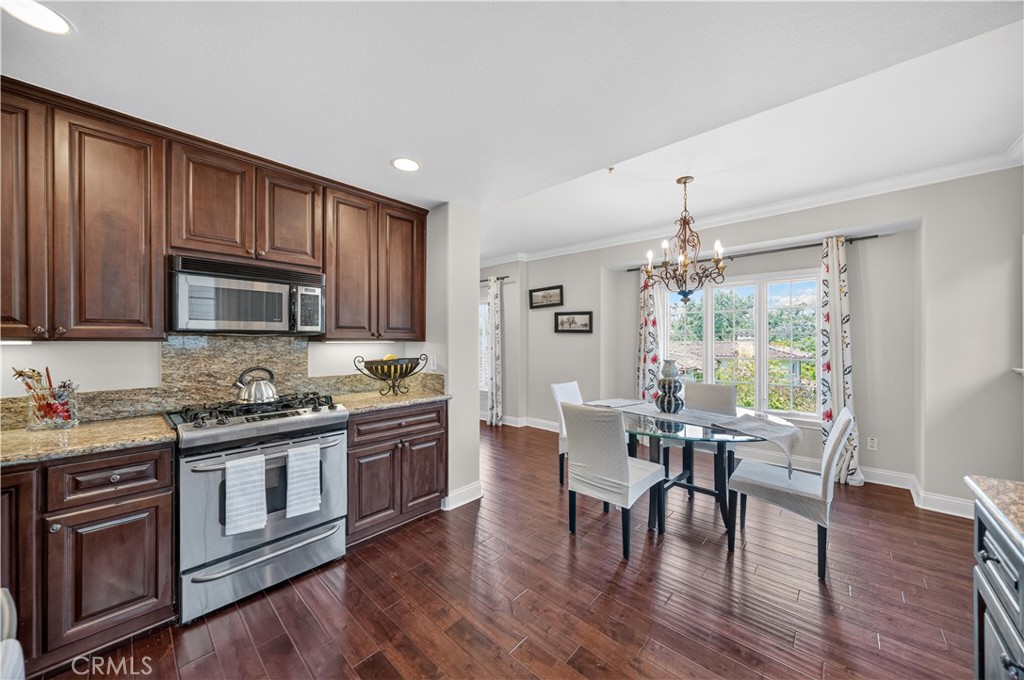 2454 Oswego Street, Unit 301 Pasadena, CA 91107 - Photo 16 of 59 a kitchen with stainless steel appliances wooden floors and wooden cabinets
