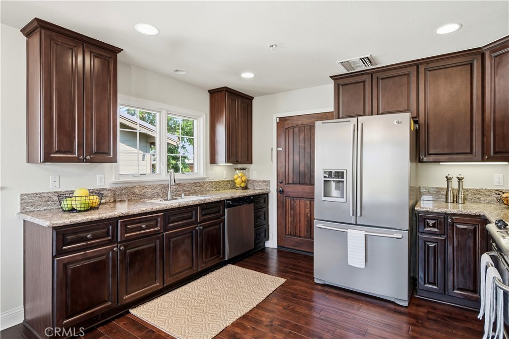 2454 Oswego Street, Unit 301 Pasadena, CA 91107 - Photo 17 of 59 a kitchen with a refrigerator sink and wooden cabinets