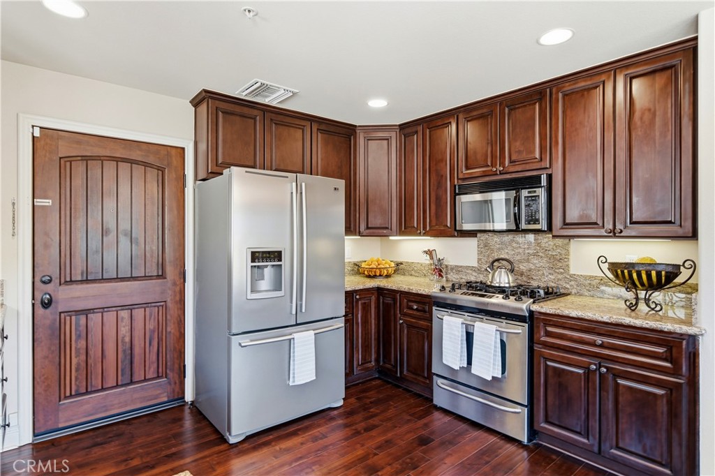 2454 Oswego Street, Unit 301 Pasadena, CA 91107 - Photo 20 of 59 a kitchen with stainless steel appliances granite countertop a refrigerator stove a sink and dishwasher with wooden floor