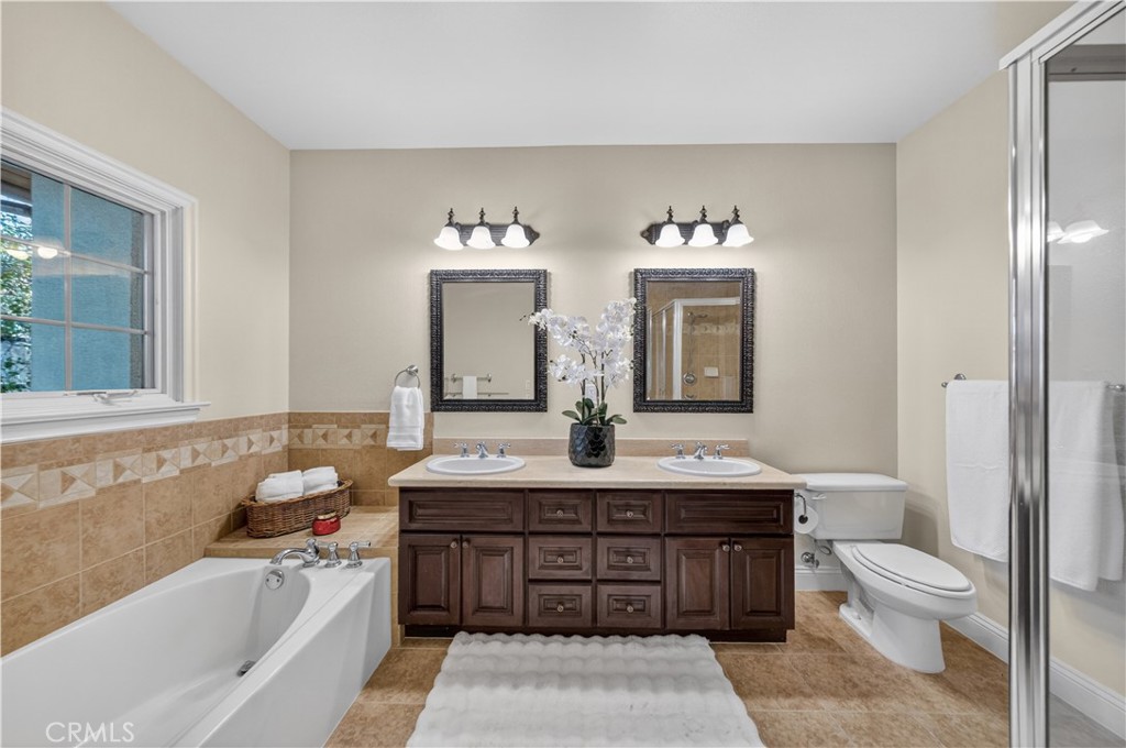2454 Oswego Street, Unit 301 Pasadena, CA 91107 - Photo 27 of 59 a bathroom with a tub sink and mirror