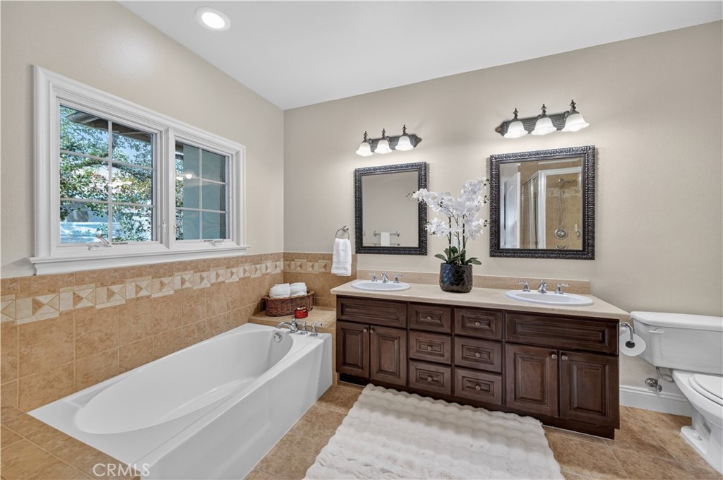 2454 Oswego Street, Unit 301 Pasadena, CA 91107 - Photo 30 of 59 a bathroom with a tub double vanity sink and a large mirror
